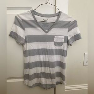 Gray and white striped t-shirt with a front pocket